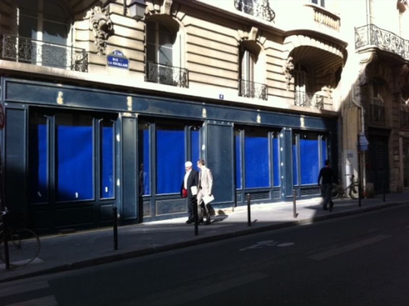 Devanture de boutique habillée de bleu nuit dans une rue parisienne